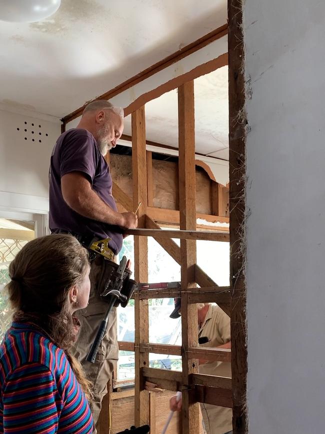 Naomi Shine, lead builder for Lismore, Two Rooms project seen here supervising the removal of flood impacted wall boards in a Lismore home. Picture: Cath Piltz