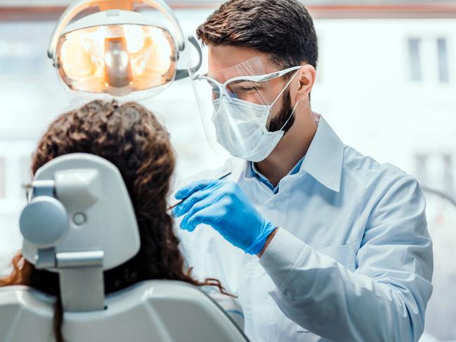 Generic dentist photo  for SAweekendDentist working in dental clinic with patient in the chair.