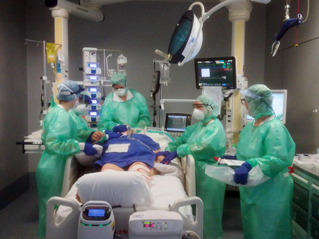 Medical staff assist a patient in the Intensive Care Unit of the Bergamo Papa Giovanni XXIII hospital in Italy. Picture: Papa Giovanni XXIII via AP.