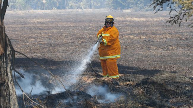 Fire fighters mop up hot spots south of Cobden as bushfires worsen. Picture: AAP/David Crosling