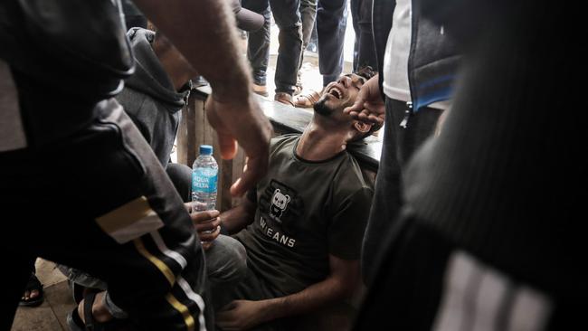 Palestinians react as civilians, injured in Israeli raids, arrive at Nasser Medical Hospital in Khan Yunis, Gaza. Picture: Ahmad Hasaballah/Getty Images