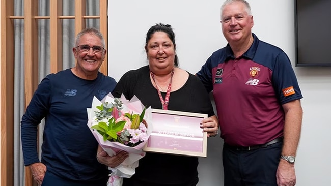 Nicole Duncan was a popular member of staff at the Brisbane Lions, where she worked for 31 years. Pictured here with Lions coach Chris Fagan and CEO Greg Swann: Contributed