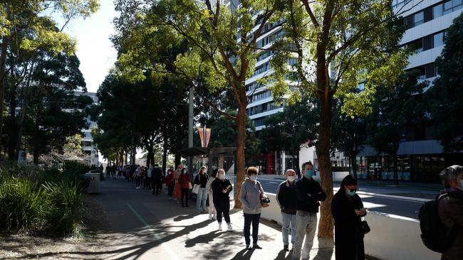 People queue to receive the Covid-19 vaccine at the New South Health Vaccination Centre at Sydney Olympic Park. Picture: Getty