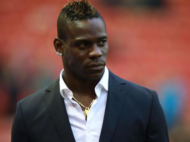 Liverpool's Mario Balotelli stands at the side of the pitch prior to the English Premier League soccer match between Liverpool and Stoke City at Anfield, Liverpool, England, Saturday Nov. 29, 2014. (AP Photo/PA, Peter Byrne) UNITED KINGDOM OUT NO SALES NO ARCHIVE