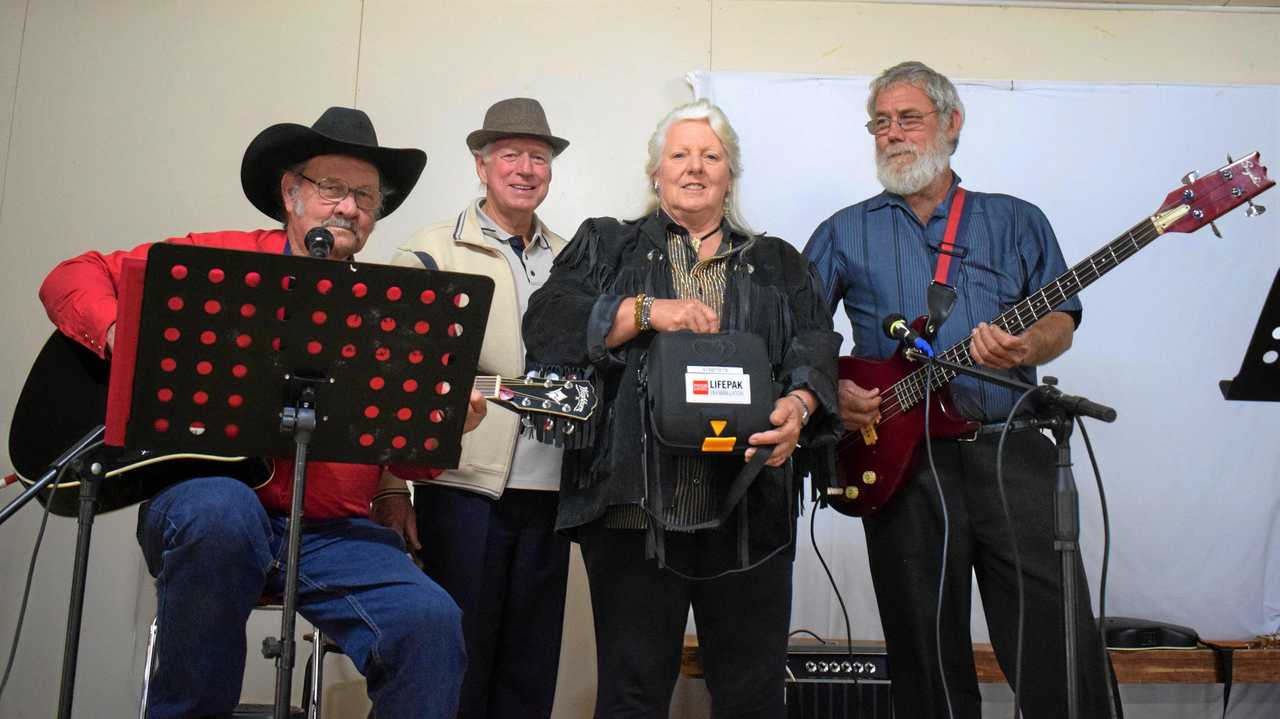 CLASSIC COUNTRY: Rob McCalister and Henry Wilson with Cammie and Charlie Bastow with the new defibrillator machine. Picture: Kate McCormack