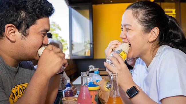 Tom and Jill enjoying their burritos as Guzman Y Gomez opens in Stuart Park, Darwin. Picture: Pema Tamang Pakhrin