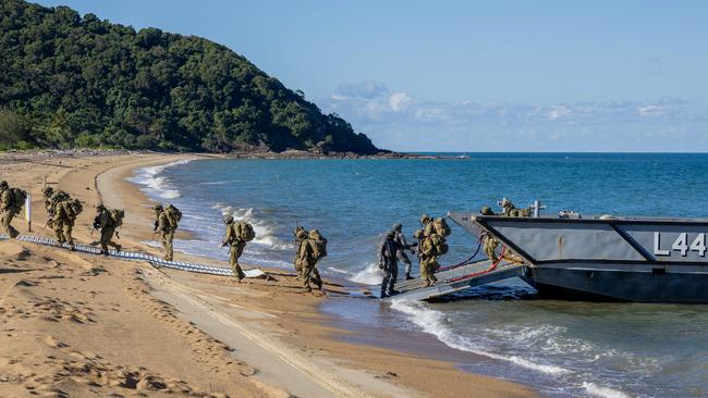 Soldiers, sailors and aviators from the Australian Amphibious Force disembark an LHD Landing Craft at Cowley Beach, QLD, as part of the Wet and Dry Environmental Rehearsals. Photo: CAPT Annie Richardson