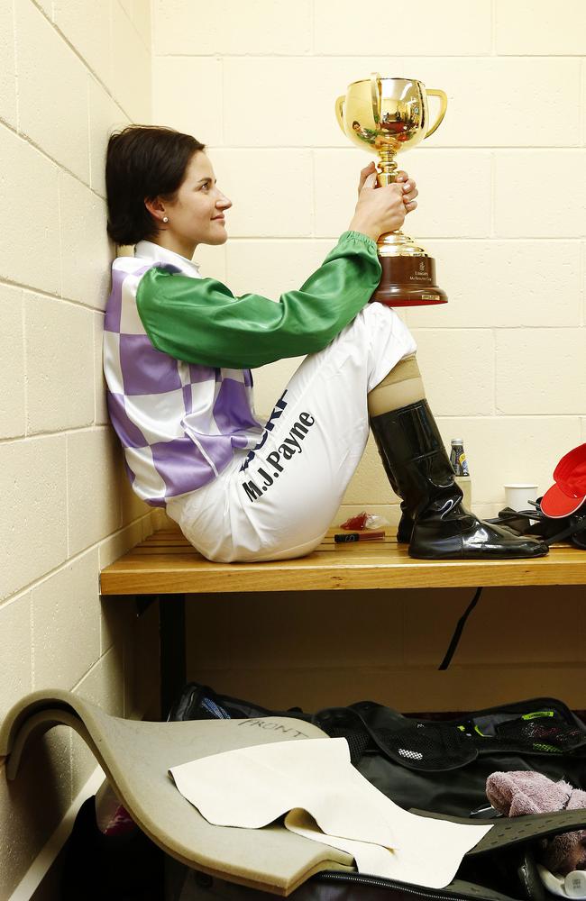 Michelle Payne spends a quiet moment in the jockeys’ room with the Melbourne Cup after her win on Prince Of Penzance. Picture: Colleen Petch