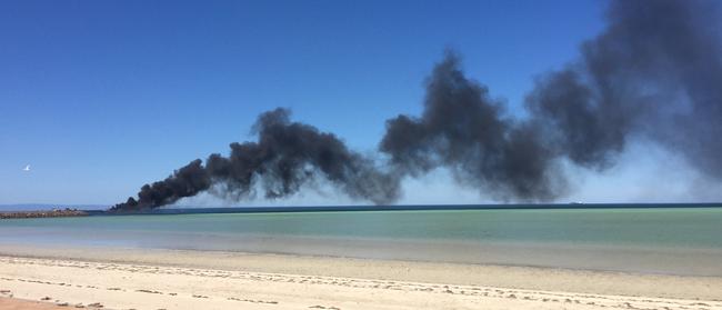 The fire sends a huge plume of black smoke into the air. Picture: Andrew Story