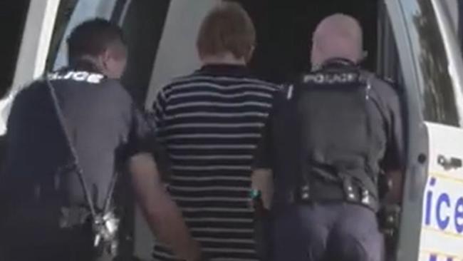 Man put into police car following alleged slashing at Kirra. Source: 9News Gold Coast