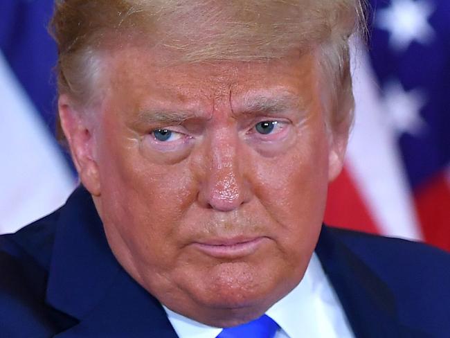 (FILES) In this file photo US President Donald Trump pumps his fist after speaking during election night in the East Room of the White House in Washington, DC, early on November 4, 2020. - US President Donald Trump hailed the 