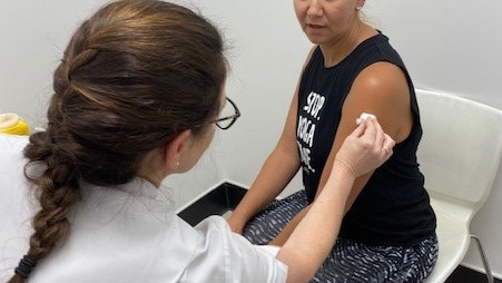 Tanya Maloney giving Barbara Haigh a flu injection at Terry White Chemmart.