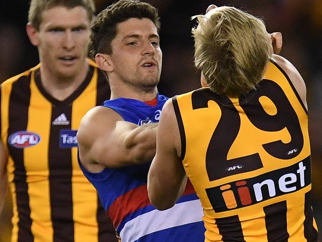 Tom Liberatore battles Hawthorn’s Will Langford. Picture: AAP Images