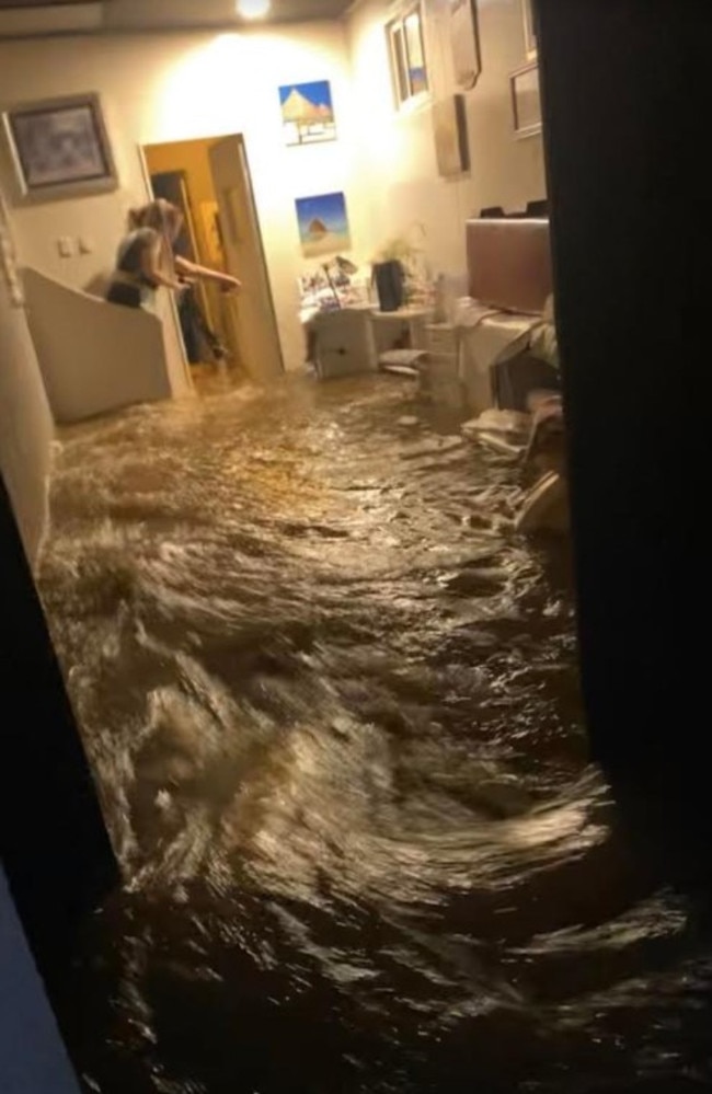 Floodwaters surged through the home, breaking open the front door. Picture: Fire and Rescue NSW (FRNSW).