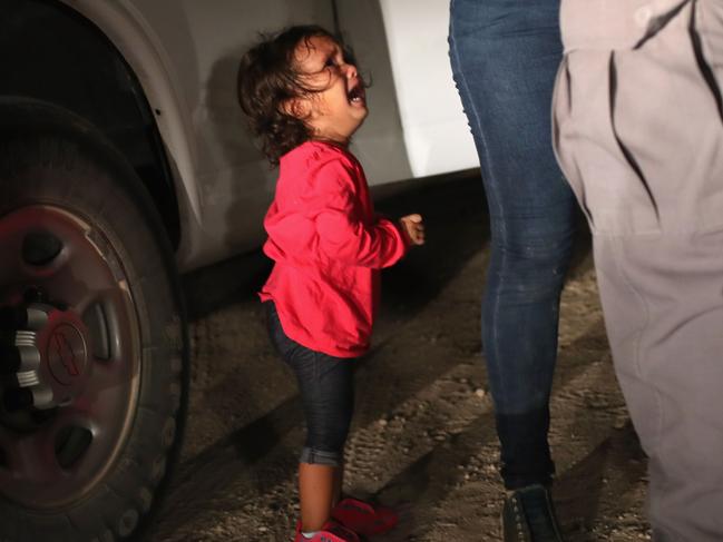 MCALLEN, TX - JUNE 12: A two-year-old Honduran asylum seeker cries as her mother is searched and detained near the U.S.-Mexico border on June 12, 2018 in McAllen, Texas. The asylum seekers had rafted across the Rio Grande from Mexico and were detained by U.S. Border Patrol agents before being sent to a processing center for possible separation. Customs and Border Protection (CBP) is executing the Trump administration's "zero tolerance" policy towards undocumented immigrants. U.S. Attorney General Jeff Sessions also said that domestic and gang violence in immigrants' country of origin would no longer qualify them for political asylum status.   John Moore/Getty Images/AFP == FOR NEWSPAPERS, INTERNET, TELCOS & TELEVISION USE ONLY ==