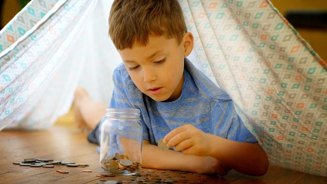 Kids are visual creatures, so nothing works as well as shiny coins that clink as they hit a glass jar.