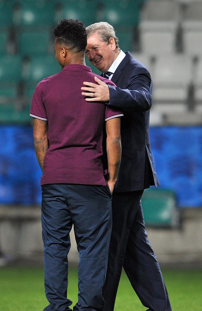 England manager Roy Hodgson (R) talks to midfielder Raheem Sterling.