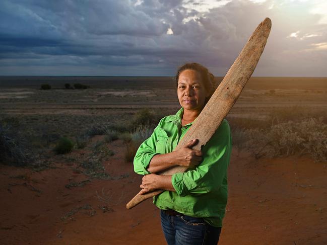 Aug 2022: Mithaka elder Trudy Gorringe holds one of two extremely rare rainforest swords, (discovered in the mud of nearby King creek south of Bedourie), on top of a red sand hill, near King creek south of Bedourie , QLD. The unusual swords have only just come to the attention of researchers and have been scientifically tested to have come from an area somewhere between Townsville and Mackay, and date from around the mid to late 1800Ã¢â¬â¢s, and are believed to be an previously unknown example of indigenous trade into the desert regions of central Australia. pic Lyndon Mechielsen