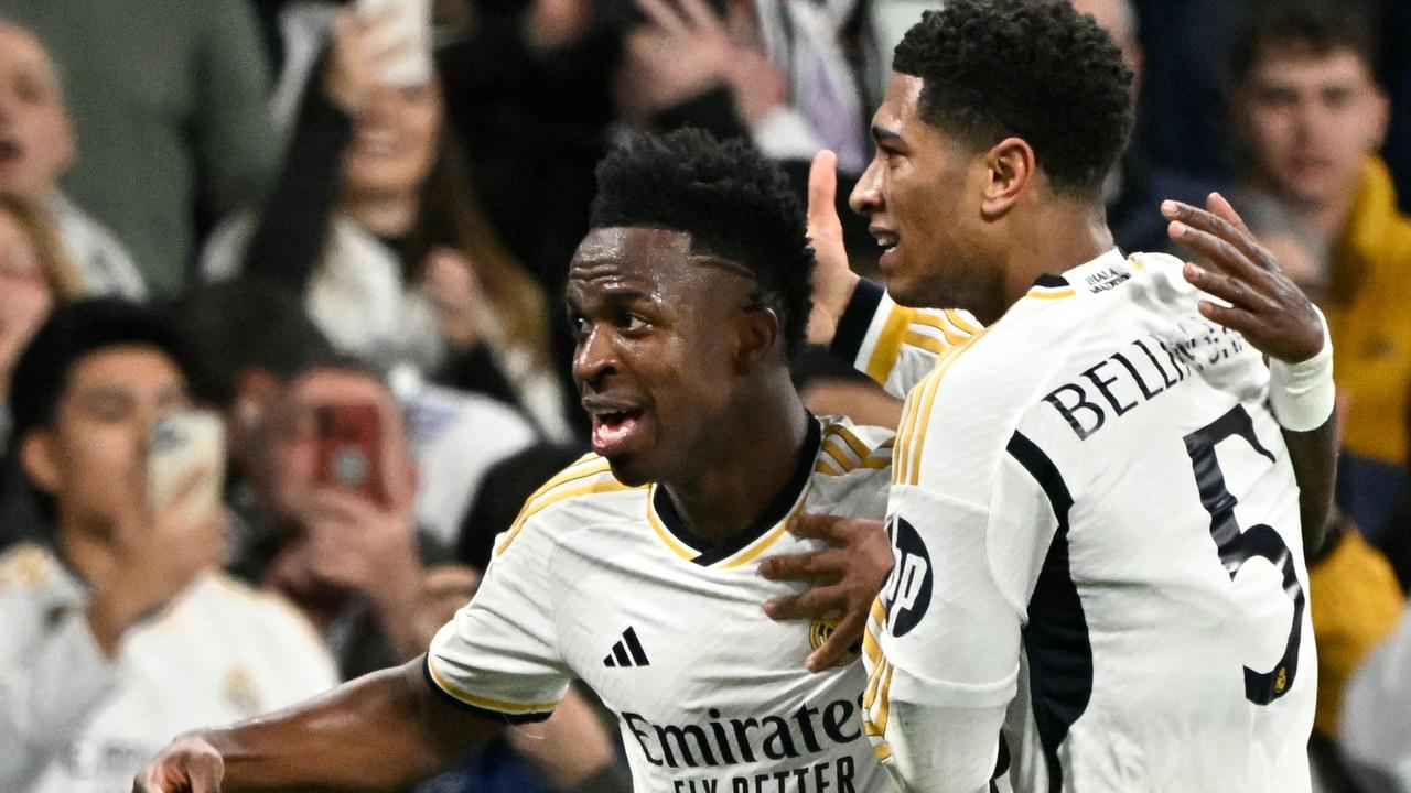 Real Madrid's Brazilian forward #07 Vinicius Junior celebrates scoring the opening goal, with Real Madrid's English midfielder #5 Jude Bellingham, during the UEFA Champions League last 16 second leg football match between Real Madrid CF and RB Leipzig at the Santiago Bernabeu stadium in Madrid on March 6, 2024. (Photo by JAVIER SORIANO / AFP)