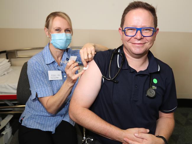 Nurse Alison Clancy vaccinates Dr Paul Griffin from Mater Health. Picture: Annette Dew