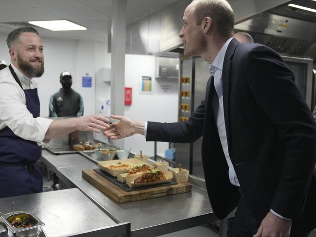 Prince William shakes hands with a chef who has prepared food in seaweed-based food containers made by Earthshot 2022 winner Notpla. Picture: Getty Images