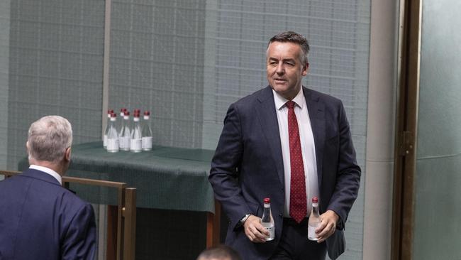 Darren Chester grabs two bottles of water for the PM. In response to the COVID19 virus a smaller group of Federal MPs were present in the chamber during Question Time in the House of Representatives at Parliament House in Canberra. Picture Gary Ramage