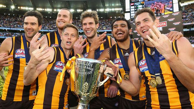 Jordan Lewis, Jarryd Roughead, Sam Mitchell, Grant Birchall, Cyril Rioli and Luke Hodge of the Hawks celebrate with the Premeirship Cup after the 2014 AFL Grand Final match.