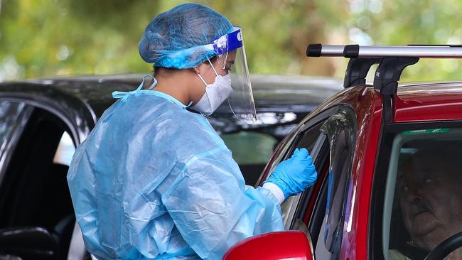 SYDNEY, AUSTRALIA - NewsWire Photos, DECEMBER 20 2021: People are seen lining up to get a Covid-19 test at the Burwood Covid Testing clinic in Sydney ahead of Christmas as positive cases continue to rise in NSW. Picture: NCA Newswire / Gaye Gerard