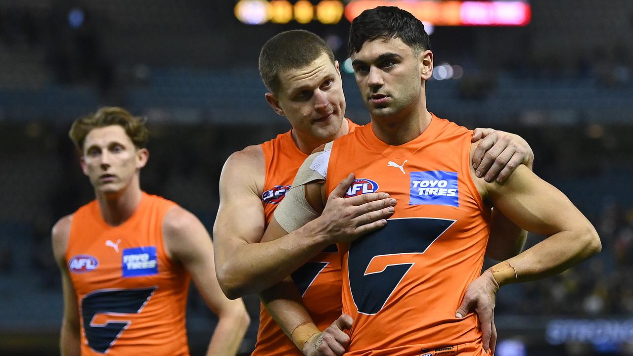 MELBOURNE, AUSTRALIA - MAY 15: Lachie Whitfield, Jacob Hopper and Tim Taranto of the Giants look dejected after losing the round 9 AFL match between the Richmond Tigers and the Greater Western Sydney Giants at Marvel Stadium on May 15, 2021 in Melbourne, Australia. (Photo by Quinn Rooney/Getty Images)