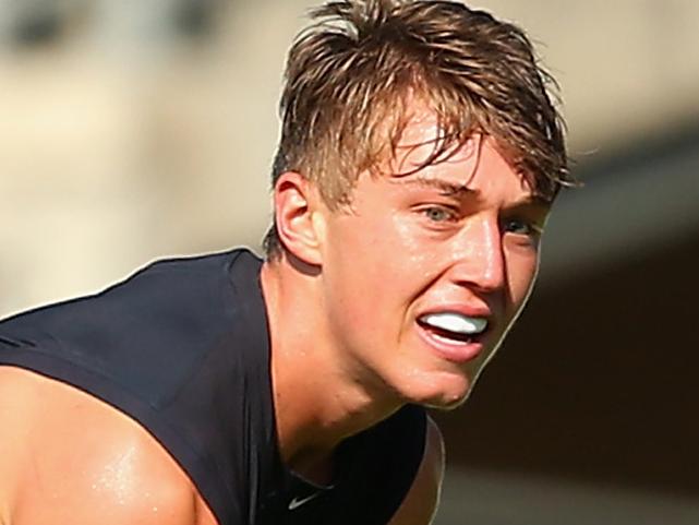 MELBOURNE, AUSTRALIA - FEBRUARY 20: Patrick Cripps of the Blues handballs whist being tackled during the Carlton Blues AFL Intra-Club match at Ikon Park on February 20, 2015 in Melbourne, Australia. (Photo by Quinn Rooney/Getty Images)