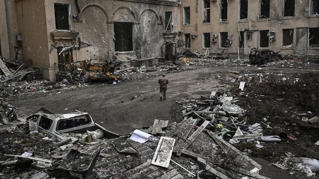 A Ukrainian serviceman walks through rubble in Kharkiv. Picture: Aris Messinis/AFP