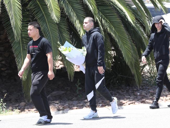 Family members and friends leave flowers at the scene of Konshu’s death. Picture: David Crosling