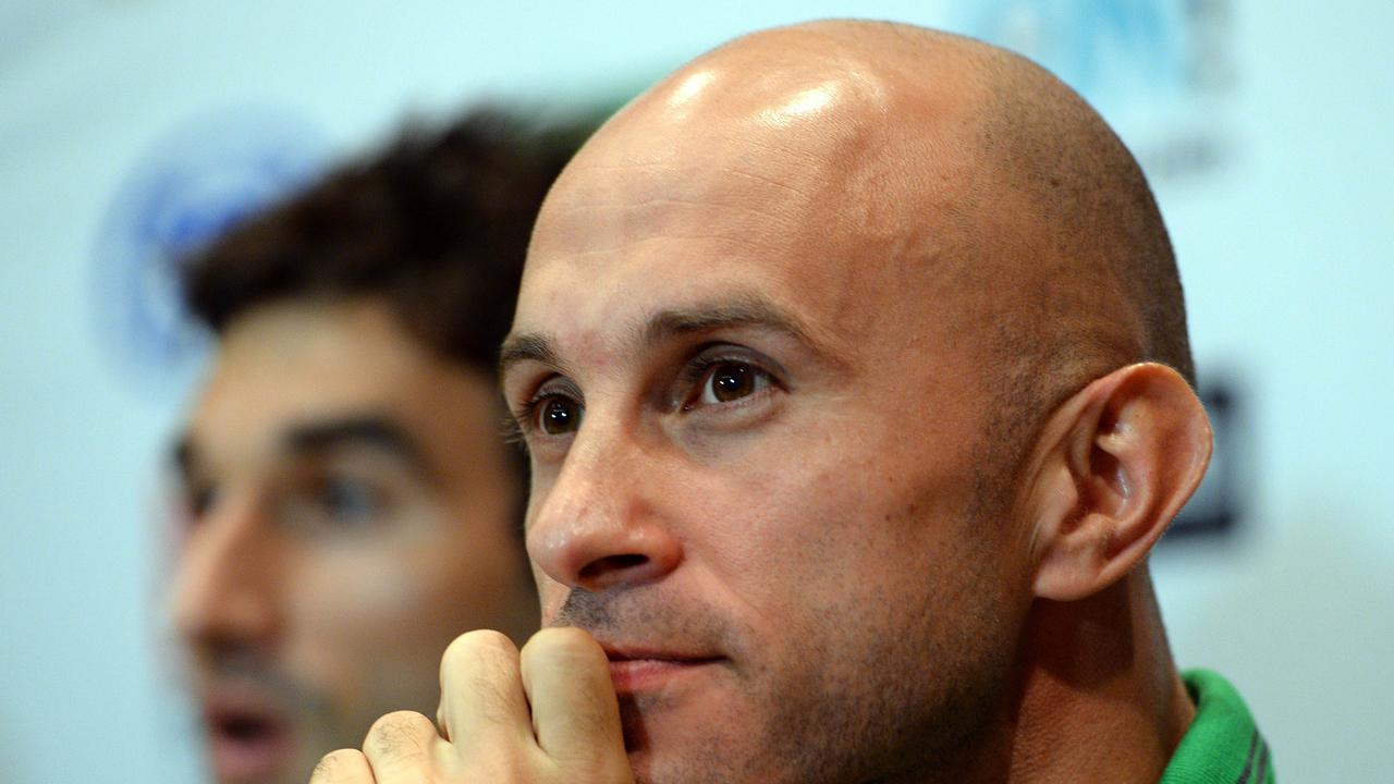 Australian national soccer team Socceroos player Mark Bresciano (R) looks on as midfielder Mile Jedinak (L) speaks at a press conference in Gosford on May 21, 2014. Crystal Palace midfielder Mile Jedinak was named captain of Australia's World Cup squad following the axing of Lucas Neill. AFP PHOTO / Saeed KHAN --IMAGE RESTRICTED TO EDITORIAL USE - STRICTLY NO COMMERCIAL USE--