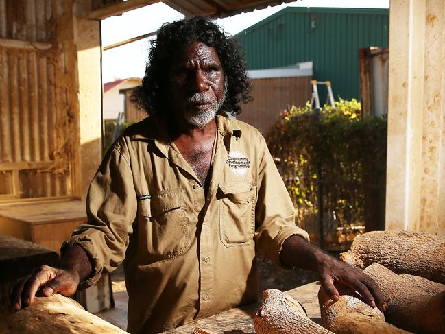 Aurukun artist Garry Namponan carves the famous camp dog sculptures and owls out of milk wood at the Wik and Kugu Arts Centre in Aurukun, an indigenous community on the Gulf of Carpentaria, 800 kilometres north west of Cairns on Cape York in Far North Queensland. PICTURE: BRENDAN RADKE..