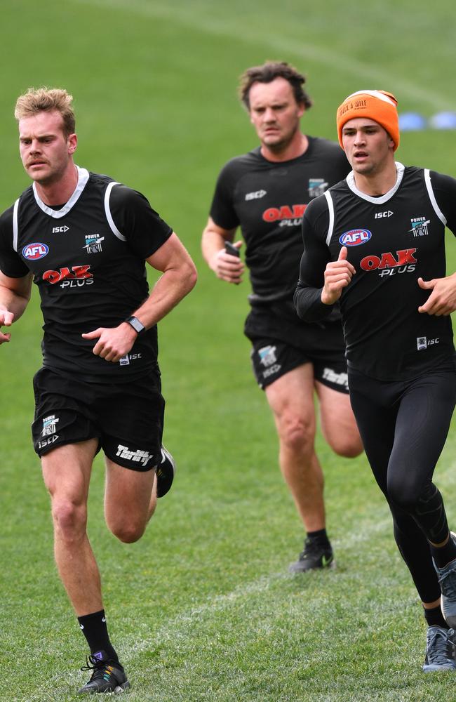 Jack Watts and Ryan Burton running at training on Friday as they track towards a return to football. Picture: David Mariuz (AAP).