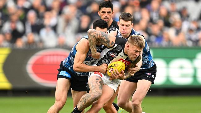 Jordan De Goey of the Magpies is tackled by Matthew Kennedy of the Blues during the round 10 AFL match between Carlton Blues and Collingwood Magpies at Melbourne Cricket Ground, on May 21, 2023, in Melbourne, Australia. (Photo by Quinn Rooney/Getty Images)