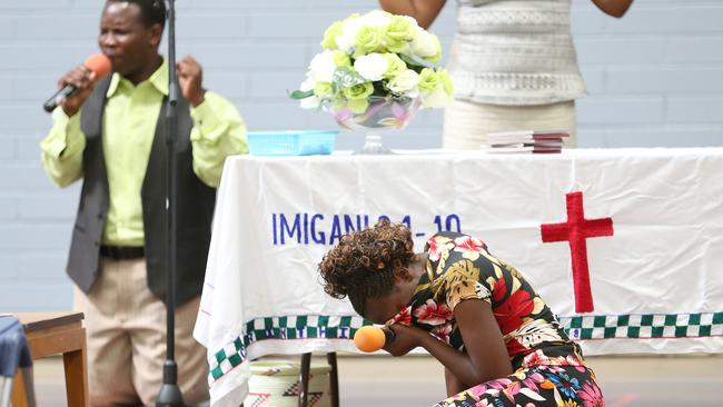 Members of the Amazing Grace Gospel Church mourn the two young boys who drowned. Picture: Stephen Laffer