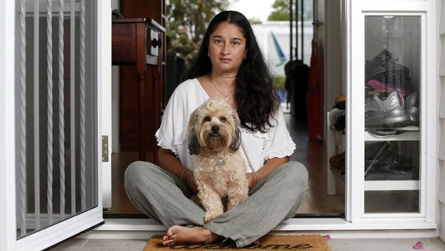 Sharon with Chewie her dog pictured at her home in Wavell Heights. In 2019 Chewie was poisoned at the same time her car was stolen. (Image/Josh Woning)