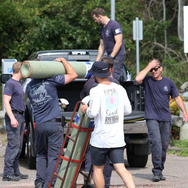 Police divers pack up their equipment at Nelson Bay Marina following an intensive search and rescue mission for the helicopter. Picture: Peter Lorimer