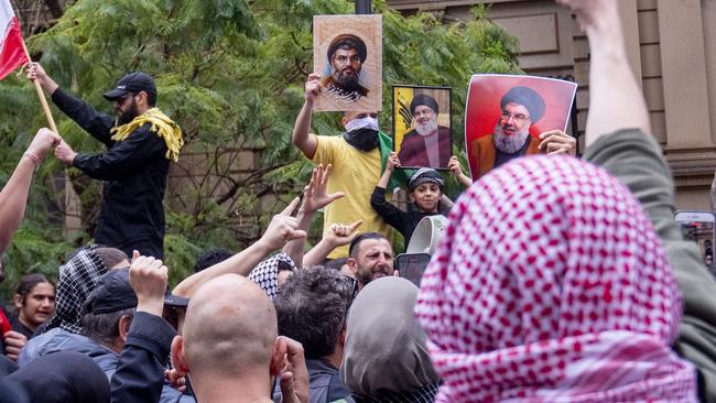 Protesters march through the streets of Sydney CBD waving pictures of Hezbollah leader Hassan Nasrallah who was killed in an IDF strike. Picture: Jeremy Piper