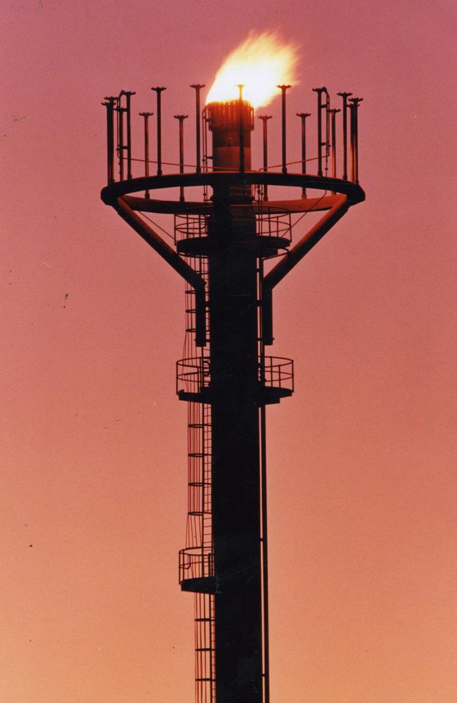 Santos Ltd's oil and gas operations at Moomba, SA, silhouetted against an Outback sunrise.