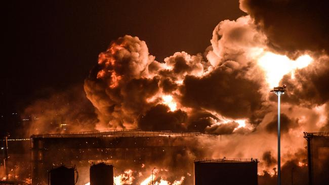 TOPSHOT - Smoke and flames rise from a Saudi Aramco oil facility in Saudi Arabia's Red Sea coastal city of Jeddah