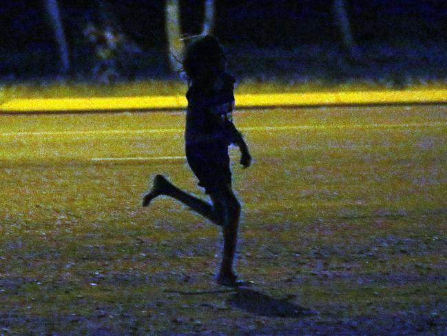 A young girl runs past a petrol station in Tennant Creek. Children as young as seven roam the streets in Tennant Creek NT. From 10pm through to the early hours of the morning children were spotted wondering the streets. Some as young as 11 years old.Picture Gary Ramage