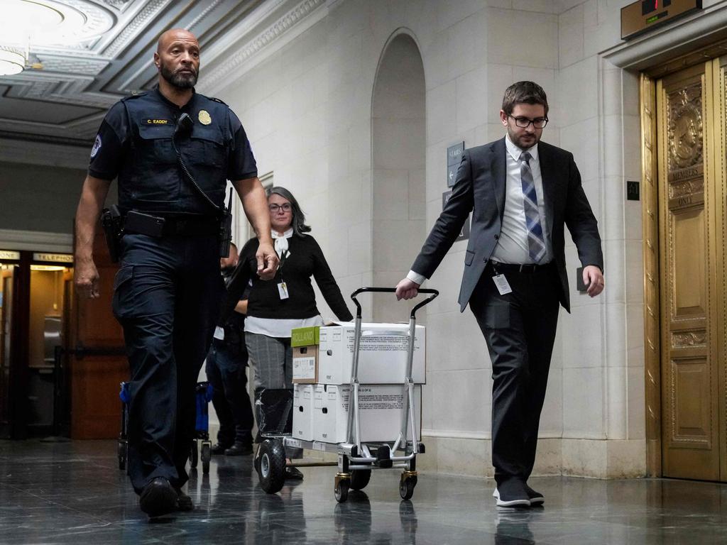 Staff members move boxes of documents from the hearing room to the office of the House Ways and Means Committee. Picture: Getty Images via AFP