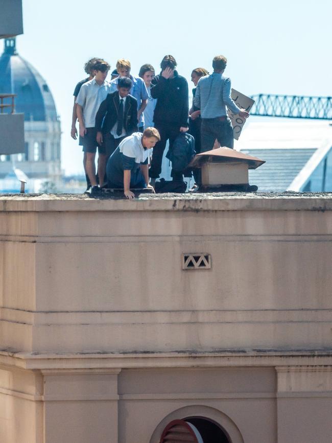 Students on the eight-storey-plus building. Picture: Jason Edwards