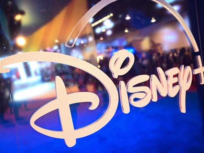 (FILES) Fans are reflected in Disney+ logo during the Walt Disney D23 Expo in Anaheim, California on September 9, 2022. Disney reported on August 7, 2024, better revenues than anticipated in the most recent quarter, atop a first profit in its streaming business, while its theme parks came under pressure. The company saw revenues of $23.2 billion, beating projections of $23.1 billion, while overall profits reached $2.6 billion. (Photo by Patrick T. FALLON / AFP)