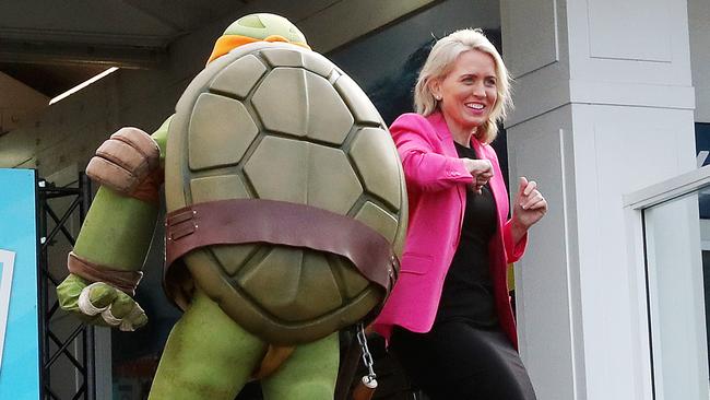 Minister Kate Jones elbow bumps a Teenage Mutant Ninja Turtle. Picture: NIGEL HALLETT