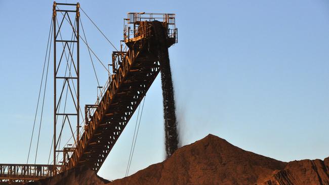 stock mining pics Iron ore being stockpiled at Fortescue Metals Group's first mine, Cloudbreak, about 280km southeast of Port Hedland in Western Australia. AAP Image/Rebecca Le May (NO ARCHIVING) * The pics were taken on a media tour on Monday.