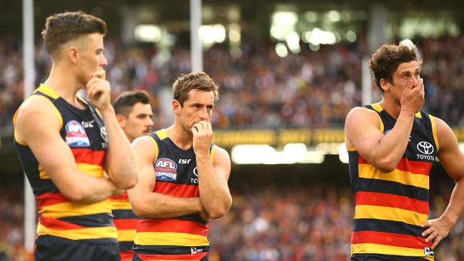 Dejected Adelaide players Paul Seedsman, Taylor Walker, Richard Douglas and Kyle Hartigan after defeat in the 2017 AFL Grand Final. Picture: Getty Images