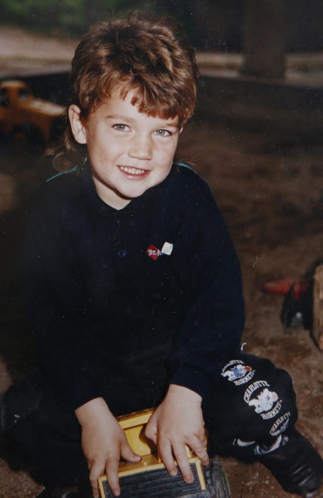 Dustin Martin playing with a toy truck as a young boy.